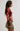 A woman shown in side profile wearing a sheer long-sleeve top with a bold orange, red, and yellow floral print over a mauve base, paired with an olive green mini skirt.