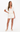 Woman wearing a white outfit on a white background