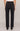 Person wearing black jeans on a plain background
