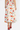 Woman wearing a floral dress with red accents on a white background
