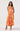 Woman wearing a colorful floral dress on a white background