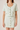 Light green two-piece outfit with buttons on a plain background