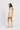 Woman wearing a floral dress and beige knee-high boots on a white background