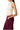 A woman shown in side profile wearing a cream ruched sleeveless crop top and dark burgundy cargo pants against a plain white background.