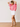 Woman wearing a pink striped shirt and white shorts against a plain background