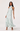 Woman wearing a light blue floral dress on a white background