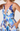 Woman wearing a blue floral dress on a white background