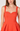 Orange dress worn by a model on a white background