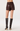 A model shown from the back wearing dark brown faux-leather shorts and matching dark brown knee-high stiletto boots against a plain light gray studio background.