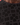 Close-up of a black textured fabric with floral patterns