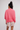 Woman wearing a linen oversized top in tart berry