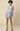 Woman wearing a floral dress on a beige background
