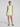 Woman wearing a light green sleeveless top and shorts on a white background