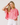 Woman wearing a pink striped shirt against a plain background