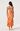 Woman wearing a colorful floral dress with a white background