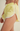 Yellow shorts with white trim on a neutral background