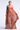 Woman wearing a strapless, layered dress with a gradient of brown and red on a white background