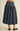 A person shown from the back wearing a dark blue denim midi skirt with a gathered waist and brown suede flats, against a plain beige studio background.