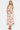 Woman wearing a floral dress with red and orange flowers on a white background