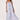 Woman wearing a strapless dress with blue and white pattern on a white background