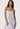 Woman wearing a strapless dress with watercolor pattern on a white background