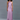 Woman wearing a long, light purple dress against a gray background