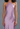 Lavender halter neck dress on a plain background