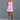 Model wearing a pink strapless dress against a gray background