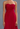 Red strapless gown on a plain background
