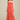 Woman wearing a strapless, ruched coral gown against a plain background