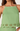 Green tank top with lace details on a plain background