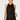A woman modeling a black satin halter dress with black lace trim at the neckline and hem, set against a plain light gray studio background.