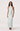 Woman wearing a light blue floral dress on a white background