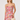 Woman wearing a floral dress holding a beige handbag on a white background