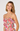 Woman wearing a floral dress against a plain background