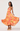 Woman wearing a colorful floral dress on a white background