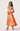 Woman wearing a colorful floral dress on a white background