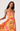 Woman wearing a colorful floral dress on a white background
