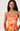 Woman wearing a colorful floral dress against a white background