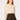 A woman modeling a cream long-sleeve blouse with a lace ruffled collar and bow tie detail, paired with a dark brown pleated mini skirt, against a plain light gray studio background.