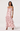 Woman wearing a pink floral dress on a white background