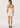 Woman wearing a strapless beige dress on a white background