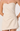 Beige strapless dress on a plain background