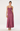 A woman modeling a sleeveless maxi dress with a structured, corset-style lace bodice and a flowing satin-like skirt in a dusty rose or mauve shade, standing against a plain light gray studio background.