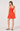 Woman wearing an orange dress on a white background