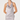 A woman modeling a light silver-gray satin halter slip dress with a cowl neckline, lace trim at the hem, and a matching lace band at the waist, set against a plain light gray studio background.
