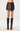 A model wearing a dark brown faux-leather wrap mini skirt and black knee-high leather boots, shown from the waist down on a light gray studio background.