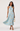 Woman wearing a light blue floral dress on a white background