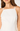 White strapless top worn by a person on a plain background