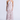 Woman wearing a long, tiered dress with a floral pattern on a white background